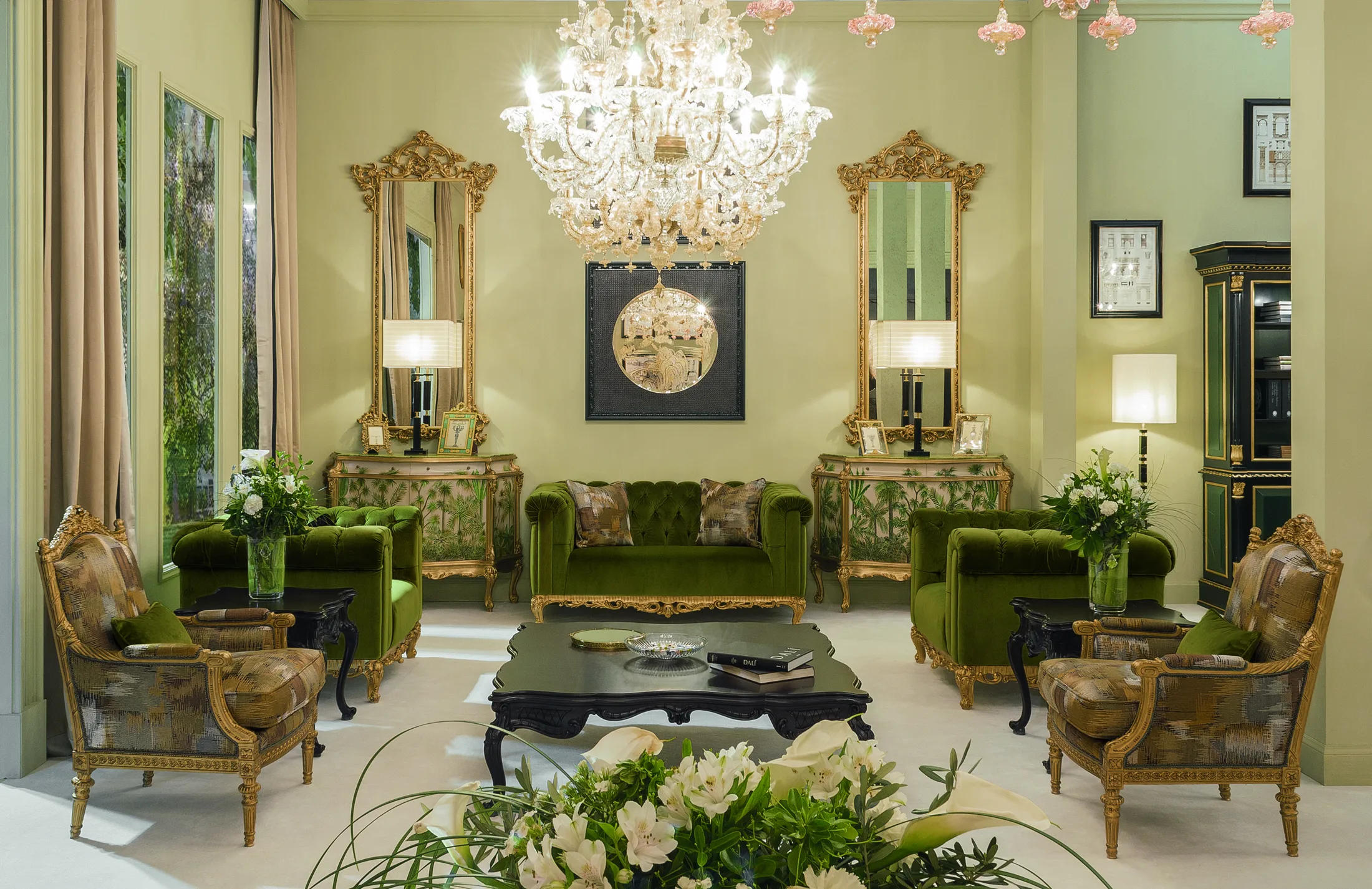 Salon of a classic Italian palazzo furnished by Fratelli Radice, with gilded mirror and console table, bordeaux damask walls and herringbone parquet