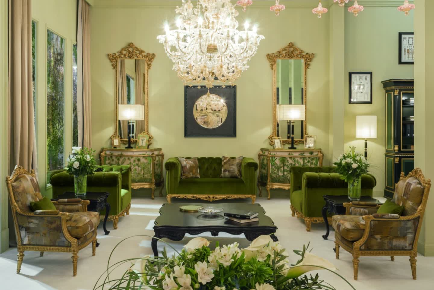 Salon of a classic Italian palazzo furnished by Fratelli Radice, with gilded mirror and console table, bordeaux damask walls and herringbone parquet